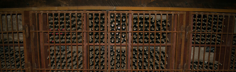 Rows of Stacked Wine Bottels Behind Locked Cage in an Underground Wine Cellar in Santiago Chile