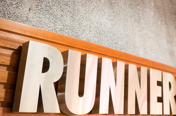 silver color metal runner sign board detail view