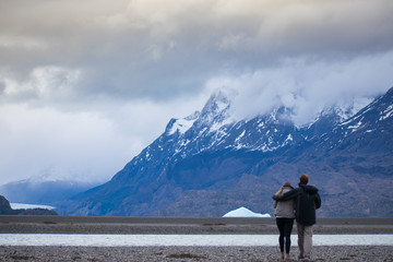 Married Couple Looking At Glacier Grey in Patagonia Chile in Torres Del Paine Mountain - Global...
