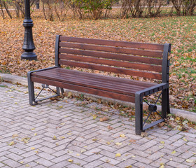 old wooden bench in a quiet autumn city part park. background, nature.