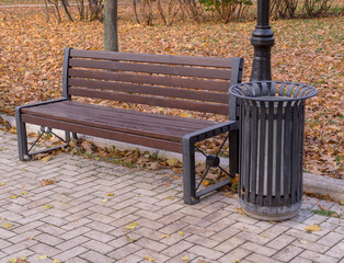 old wooden bench in a quiet autumn city part park. background, nature.