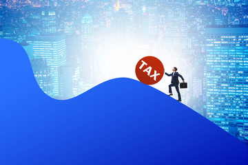 Businessman in tax concept on mountain