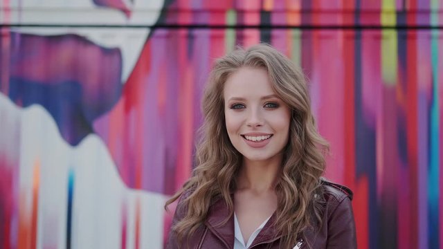Portrait of a cute girl with a charming prepossessing smile. young woman looking at camera and smiling.