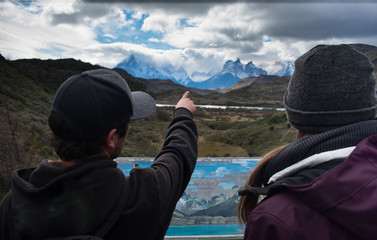 Hikers Pointing to Torres Del Paine Mountain Range in the Background in Patagonia Chile