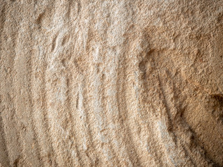 Antique stone grinding wheel side close up showing grooves.