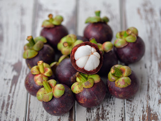 Mangosteen fruit on a wooden table.
