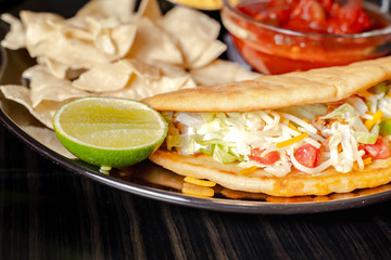Homemade Baja Fish Tacos with Mango Salsa and Chips. Mixed mexican food: Guacamole, nachos, fajita, meat tacos. Top view. Tex-mex cuisine. Assorted appetizers. Cuisine of Mexico