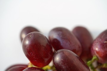 macro view on bright red grapes on light background