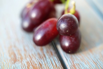 fresh red seedless grapes on wooden background