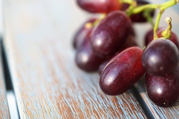 fresh red grapes on wooden background