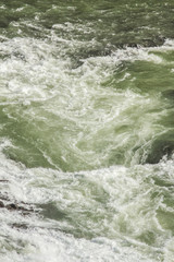 A three-step staircase of the Gullfoss waterfall on Hvita river, as pictured in detail (water plunging into the canyon, mossy cliffs, thick spray, panorama of the rapids)