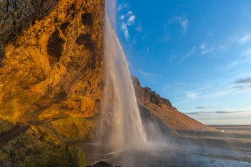 Fototapeta na wymiar Waterfall Seljalandsfoss (part of Seljalands river taking its origin in Eyjafjallajökull volcano glacier) in southern Iceland, as seen in sunset hour