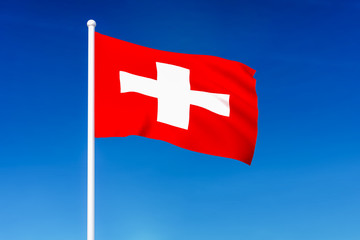 Waving flag of Switzerland on the blue sky background