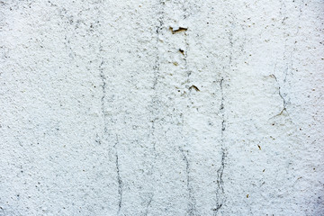 Texture of a concrete wall with cracks and scratches which can be used as a background