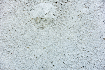 Texture of a concrete wall with cracks and scratches which can be used as a background