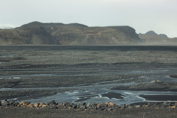 An outwash plain Mýrdalssandur in Iceland built by jokulhaups of the Mýrdalsjökull glacier which jokulhaups were caused by volcanic activity and eruptions of Katla that sits underneath its ice sheet