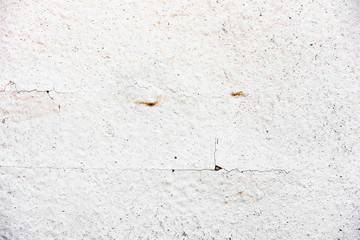 Texture of a concrete wall with cracks and scratches which can be used as a background