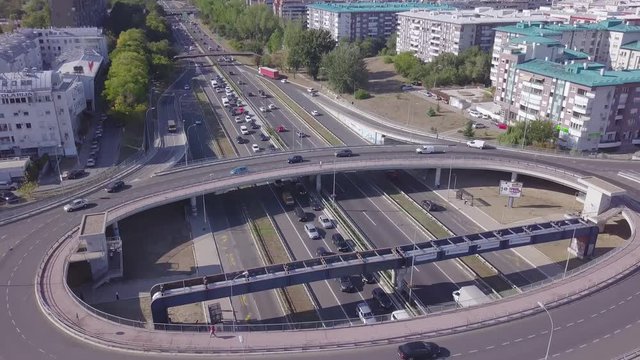 Tilting 4k aerial shot of Roundabout and highway near Arena and Genex
