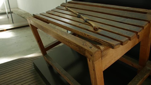 The tortures weapons vintage old wooden stick baton cane place for public punishment prison house jail gaol pokey colony concentration camp