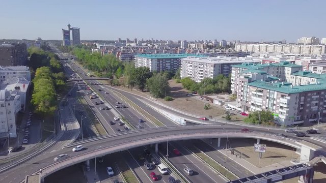 Slow opening aerial shot of roundabout and highway in Belgrade, Genex tower