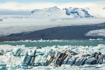 Tongue of the Breiðamerkurjökull glacier as it retreats into glacier lagoon Jökulsárlón leaving floating icebergs (Vatnajökull National Park in Iceland)