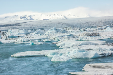 Tongue of the Breiðamerkurjökull glacier as it retreats into glacier lagoon Jökulsárlón leaving floating icebergs (Vatnajökull National Park in Iceland))