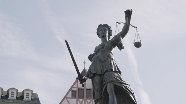 Static shot of Justitia Statue at r&ouml;mer place, at daylight, closeup with clear sky, frankfurt, hessen, Germany