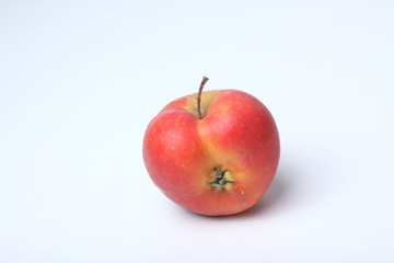 Concept of ugly food - red apple on white background