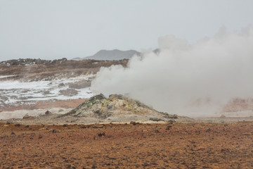 Panorama of geothermal area Hverarönd (Hverir), situated by the orange-red clay coloured tuff mountain Namafjall south of Námaskarð in Iceland, with details and patterns