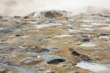 Panorama of geothermal area Hverarönd (Hverir), situated by the orange-red clay coloured tuff mountain Namafjall south of Námaskarð in Iceland, with details and patterns