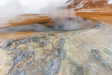 Panorama of geothermal area Hverar&ouml;nd (Hverir), situated by the orange-red clay coloured tuff mountain Namafjall south of N&aacute;maskar&eth; in Iceland, with details and patterns
