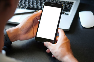 Cropped shot view of man hands holding smart phone with blank copy space screen for your text message or information content, female reading text message on cell telephone during in urban setting. 
