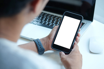 Cropped shot view of man hands holding smart phone with blank copy space screen for your text message or information content, female reading text message on cell telephone during in urban setting. 
