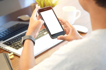 Cropped shot view of man hands holding smart phone with blank copy space screen for your text message or information content, female reading text message on cell telephone during in urban setting. 