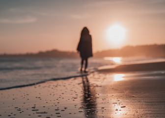 silhouette of woman on the beach at sunset