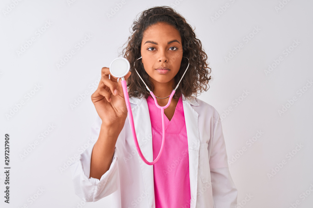 Poster Young brazilian doctor woman using stethoscope standing over isolated white background with a confident expression on smart face thinking serious