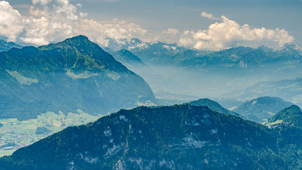 Fototapeta na wymiar Switzerland, Panoramic view on green Alps and lake Lucerne in clouds