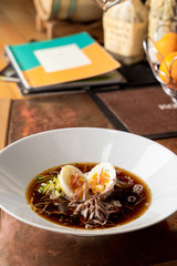 Traditional russian summer soup okroshka with kvass, eggs and fresh vegetables