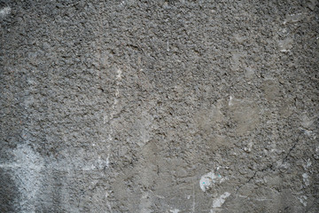 Texture of an old cracked concrete wall. Background image of a worn gray concrete surface