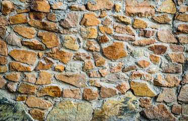 The texture of the old masonry. Background image of a stone-lined wall