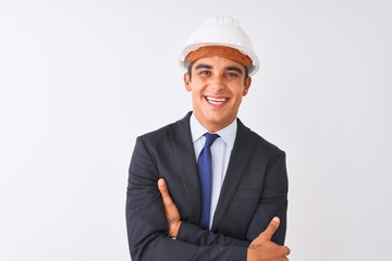 Young handsome architect man wearing suit and helmet over isolated white background happy face smiling with crossed arms looking at the camera. Positive person.