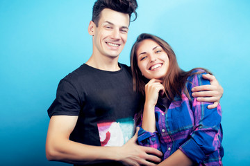 Naklejka premium happy couple together posing cheerful on blue background , guy and girl students together friends