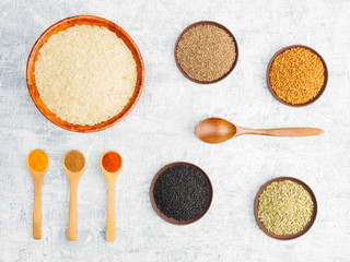 Spices set and rice on white concrete background. Modern apothecary, naturopathy and ayurveda concept.