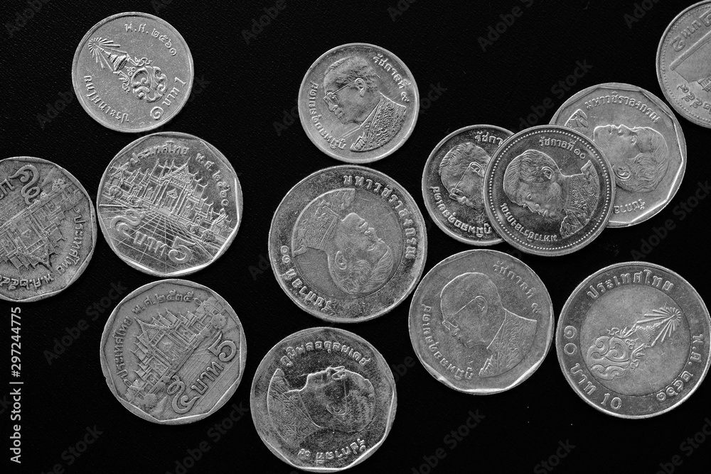 Wall mural thai baht coins on a dark background close-up, black and white