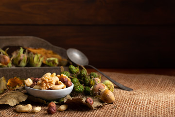 Variation of healthy nuts on a autumn background
