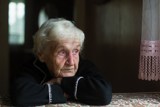 Portrait of sad elderly woman in the his house.