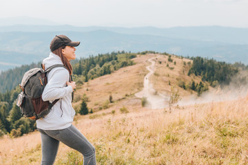 hiking concept woman with backpack at mountains peak