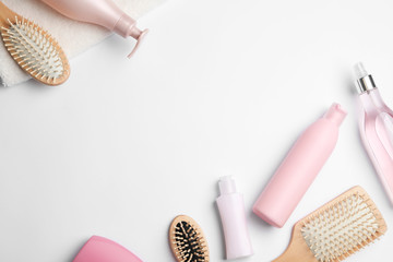 Flat lay composition with hair cosmetic products and tools on white background. Space for text