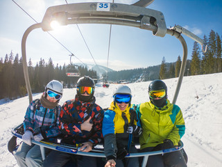 friends in ski lift taking selfie