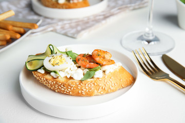 Plate of delicious bruschetta with shrimps on white table